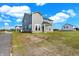 Two-story house with gray siding, covered patio, and grassy backyard at 7098 Portico Ln, McCordsville, IN 46055