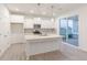 White kitchen with island, stainless steel appliances, and light-colored floors at 9310 Anthem Ave, Plainfield, IN 46168