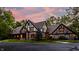 Evening view of Tudor home showcasing architectural details at 7406 Washington Blvd, Indianapolis, IN 46240