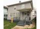 Two-story house with gray siding, front porch, and black railings at 209 N Pershing Ave, Indianapolis, IN 46222