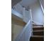 Interior view of a carpeted staircase with white railings at 209 N Pershing Ave, Indianapolis, IN 46222