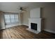 Living room featuring hardwood floors, fireplace, and built-in window seat at 209 N Pershing Ave, Indianapolis, IN 46222