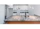 Modern kitchen island with granite countertop and farmhouse sink at 221 Eastern Ave, Indianapolis, IN 46201