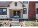 Front entrance of the house featuring a porch with columns and a screen door at 819 E 49Th St, Indianapolis, IN 46205