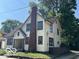 Two-story home with brick chimney and mature trees at 819 E 49Th St, Indianapolis, IN 46205