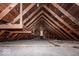 Unfinished attic space with exposed wooden beams and ample storage potential at 819 E 49Th St, Indianapolis, IN 46205