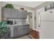 Small kitchen with gray cabinets, stainless steel appliances, and tin backsplash at 621 N State St, Greenfield, IN 46140