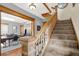 Carpeted staircase with wooden banister and detailed newel post at 621 N State St, Greenfield, IN 46140