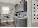 Small galley kitchen with gray cabinets, stainless steel sink, and microwave at 621 N State St, Greenfield, IN 46140