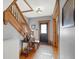 Entryway with hardwood floors, a black door, and a staircase at 621 N State St, Greenfield, IN 46140