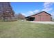 Brown barn with covered equipment storage area at 12198 E 136Th Street, Noblesville, IN 46060