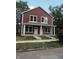 Two-story duplex with maroon siding and white trim at 217 N Temple Ave, Indianapolis, IN 46201