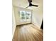 Well-lit bedroom with hardwood floors and two large windows at 217 N Temple Ave, Indianapolis, IN 46201