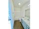 Clean bathroom with a gray vanity and a shower/tub combo at 217 N Temple Ave, Indianapolis, IN 46201