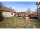 Private backyard oasis with a wooden pergola, lush lawn, and brick pathway at 1507 Broadway St, Indianapolis, IN 46202