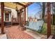 Charming backyard retreat with a porch swing under a pergola and a brick patio at 1507 Broadway St, Indianapolis, IN 46202
