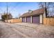 Three-car garage with a paved driveway and a wooden fence at 1507 Broadway St, Indianapolis, IN 46202