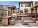 Outdoor kitchen and seating area on a paved patio with a wooden pergola at 1507 Broadway St, Indianapolis, IN 46202