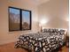 Bright bedroom with large window and patterned bedding at 855 N East St # 303-B, Indianapolis, IN 46202