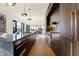 Sleek kitchen with dark wood cabinetry, stainless steel appliances, and a large island at 855 N East St # 303-B, Indianapolis, IN 46202