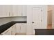 White shaker cabinets, herringbone backsplash, and dark countertops in kitchen at 6621 Flowstone Way, Indianapolis, IN 46237