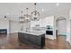 Open concept kitchen with island, white cabinets, and black island at 4212 Stone Lake Dr, Zionsville, IN 46077