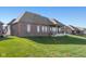 Brick house with backyard patio and grassy area at 4212 Stone Lake Dr, Zionsville, IN 46077