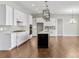 Kitchen with white cabinets, quartz countertops, and black island at 4212 Stone Lake Dr, Zionsville, IN 46077
