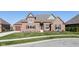 Brick house with a two-car garage and landscaped yard at 4212 Stone Lake Dr, Zionsville, IN 46077