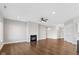 Living room with hardwood floors, fireplace, and ceiling fan at 4212 Stone Lake Dr, Zionsville, IN 46077
