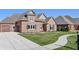 Brick house with a two-car garage and landscaped yard at 4212 Stone Lake Dr, Zionsville, IN 46077