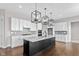 Kitchen with white cabinets, quartz countertops and black island at 4212 Stone Lake Dr, Zionsville, IN 46077