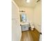 Modern bathroom with gray vanity and wood-look floors at 221 N Temple Ave, Indianapolis, IN 46201