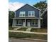 New construction duplex, featuring two units with navy siding and white trim at 221 N Temple Ave, Indianapolis, IN 46201