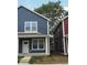 Two-story navy blue duplex home with a tree and neighboring building at 221 N Temple Ave, Indianapolis, IN 46201