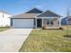 Brick and gray siding one-story home with a two-car garage and landscaped lawn at 8827 Tortugas Ct, Camby, IN 46113