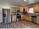 Updated kitchen with stainless steel appliances and light wood cabinets at 7303 Shamrock Dr, Indianapolis, IN 46217