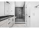 Modern bathroom with a large walk-in shower and dark tile at 525 Fynn Pl, Indianapolis, IN 46202