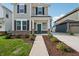 Two-story house with a green door and walkway at 5733 Arcade Blvd, McCordsville, IN 46055