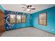 Bedroom with a blue accent wall, wood trim, and ceiling fan at 8801 Traders Lndg, Brownsburg, IN 46112