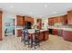 Open kitchen with island, stainless steel appliances, and rich wood cabinets at 4739 Beechwood Rd, Avon, IN 46123