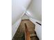 Large attic bedroom with carpet, wood railing, and dormer window at 221 Kansas St, Indianapolis, IN 46225