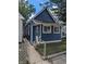 Newly renovated blue house with a chain link fence and small front yard at 221 Kansas St, Indianapolis, IN 46225