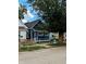 Newly renovated blue house with a wooden fence and small front yard at 221 Kansas St, Indianapolis, IN 46225