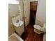 Clean bathroom with white vanity and dark hardwood floors at 221 Kansas St, Indianapolis, IN 46225
