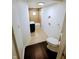 Bathroom with tile shower/tub, toilet, and dark floors at 221 Kansas St, Indianapolis, IN 46225