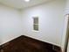 Bright bedroom with dark hardwood floors and a window at 221 Kansas St, Indianapolis, IN 46225