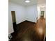 Spacious living room featuring dark hardwood floors and fresh paint at 221 Kansas St, Indianapolis, IN 46225