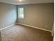 Spacious bedroom with gray walls, carpet, and a window at 863 E Harrison St, Martinsville, IN 46151