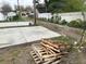 Newly poured concrete driveway with adjacent alley access at 863 E Harrison St, Martinsville, IN 46151